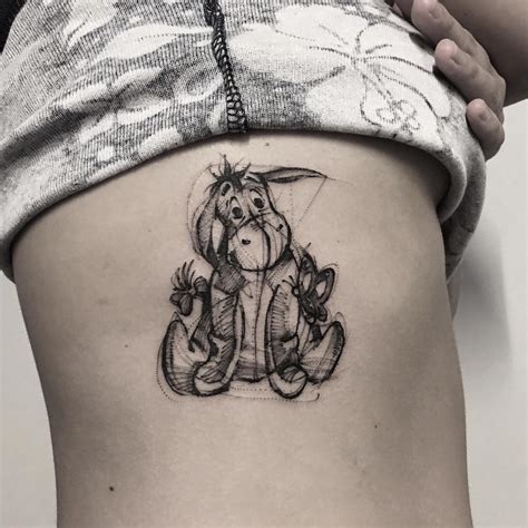 Let this whimsical artwork bring a smile to your face. . Eeyore tattoo